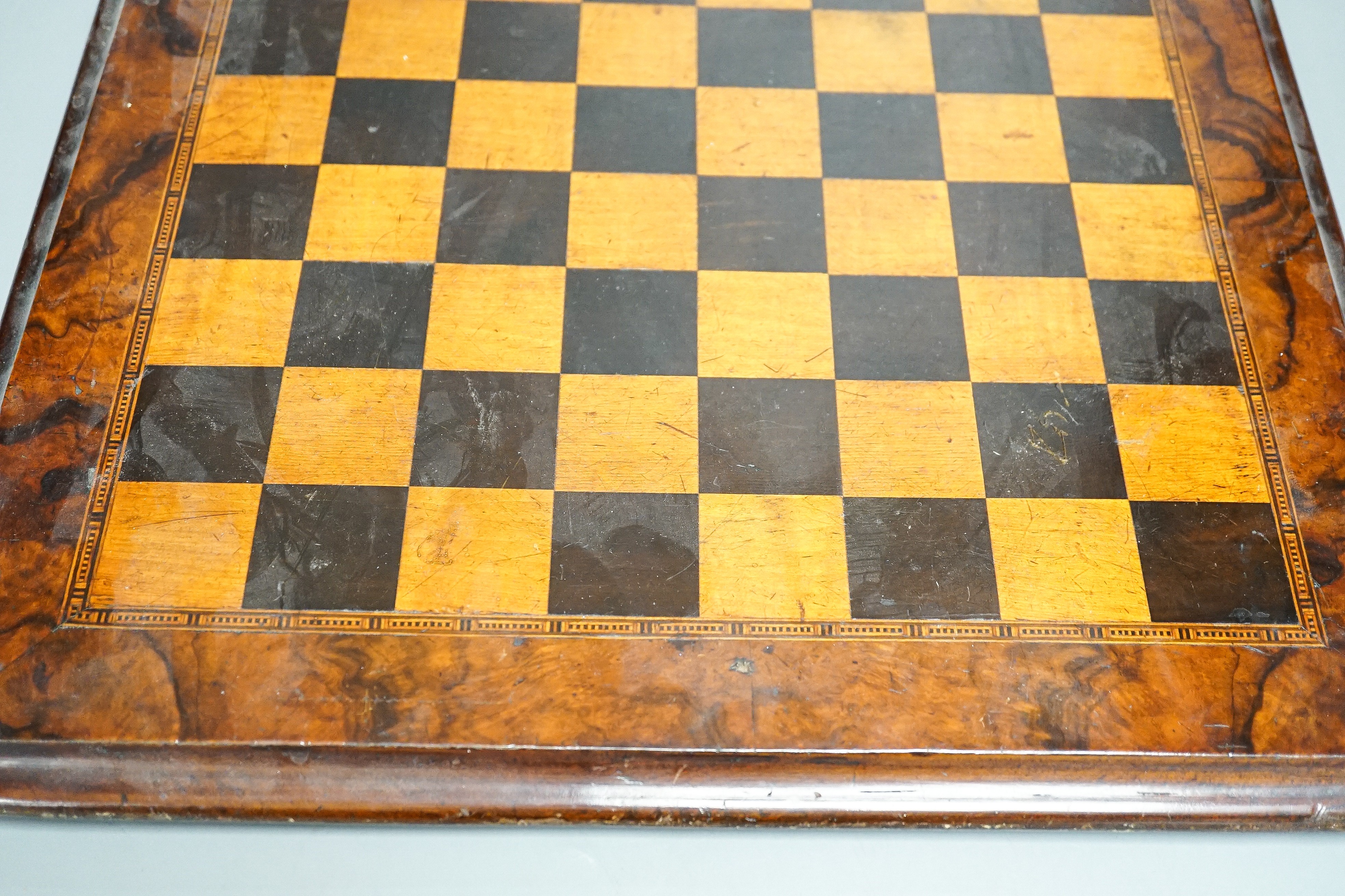 A late 19th century walnut, ebony and sycamore chessboard together with a box set of dominoes, chessboard 41cm x41cm